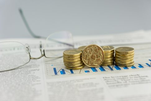 Coins on top of a newspaper