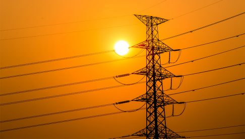 Sunset over a power line