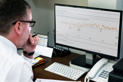 Man accessing the Grattan COVID-19 econ tracker on his computer