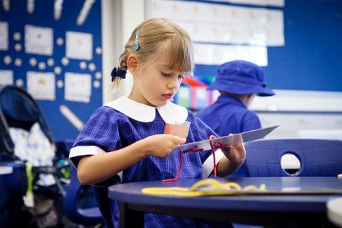 Girl at primary school doing craft