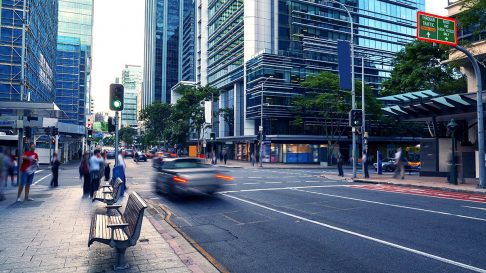 Street view of Brisbane city with a car rushing past