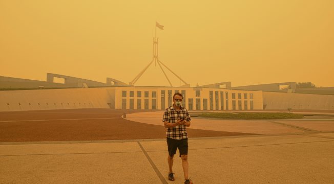 Canberra, Australia, 5/01/2020, Smoke coming from nearby forest fires creates high pollution and covers Canberra with a thick fog. People need to wear mask to breathe.