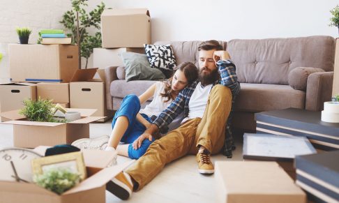 A young couple looking stressed among moving boxes