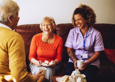 Aged care worker talking to senior people