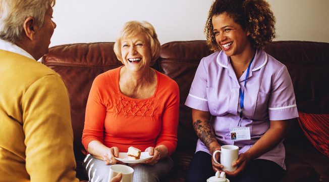 Aged care worker talking to senior people