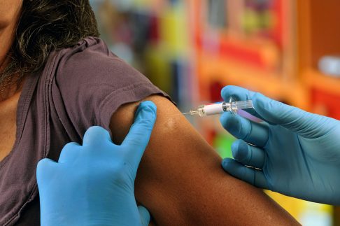 Woman receiving vaccination in arm