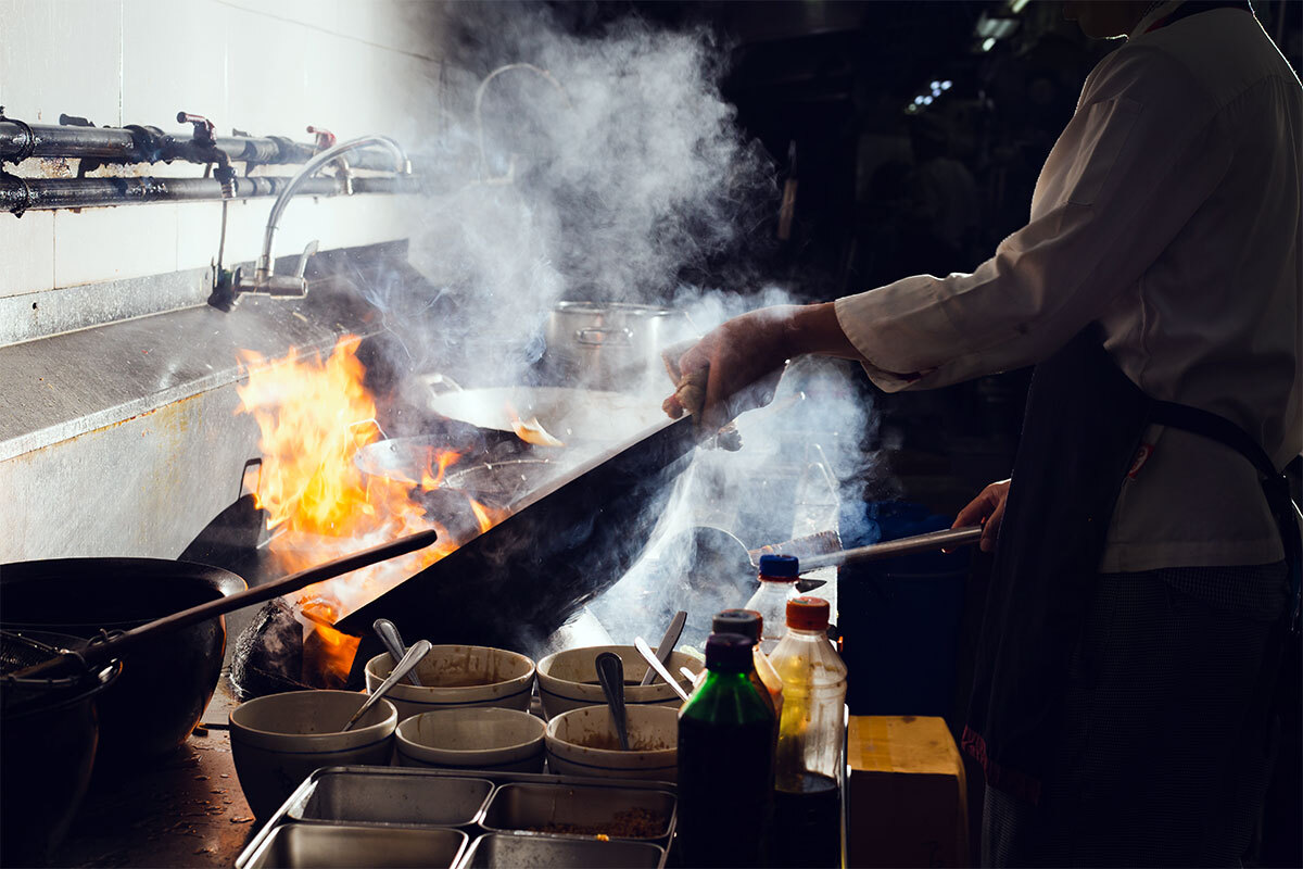 Migrant worker cooking in a kitchen