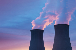 Silhouetted nuclear power plant stacks at sunset